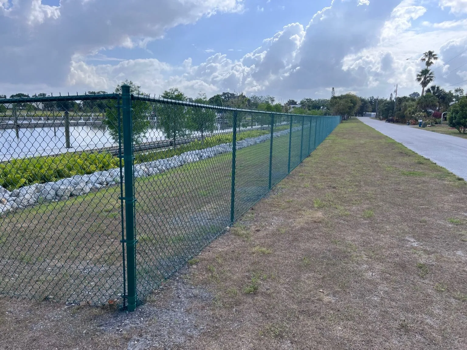 Chain-link fence along a grassy path