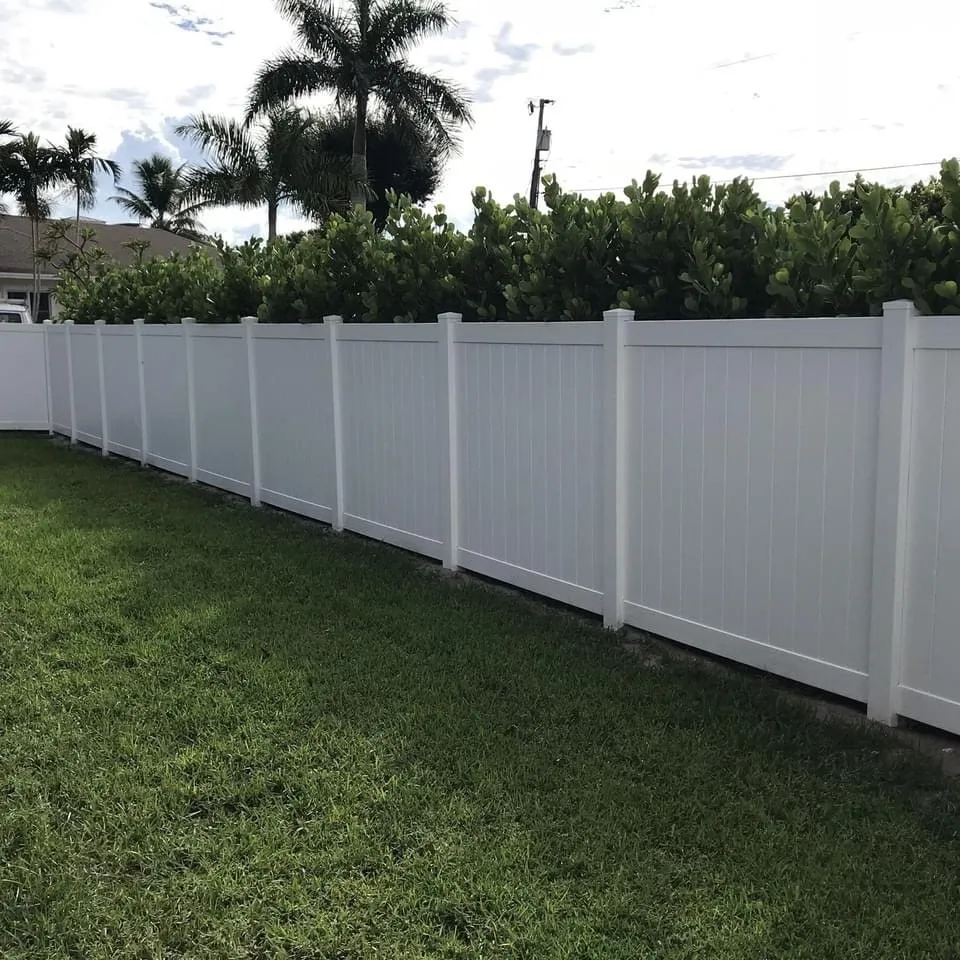 White fence with green lawn
