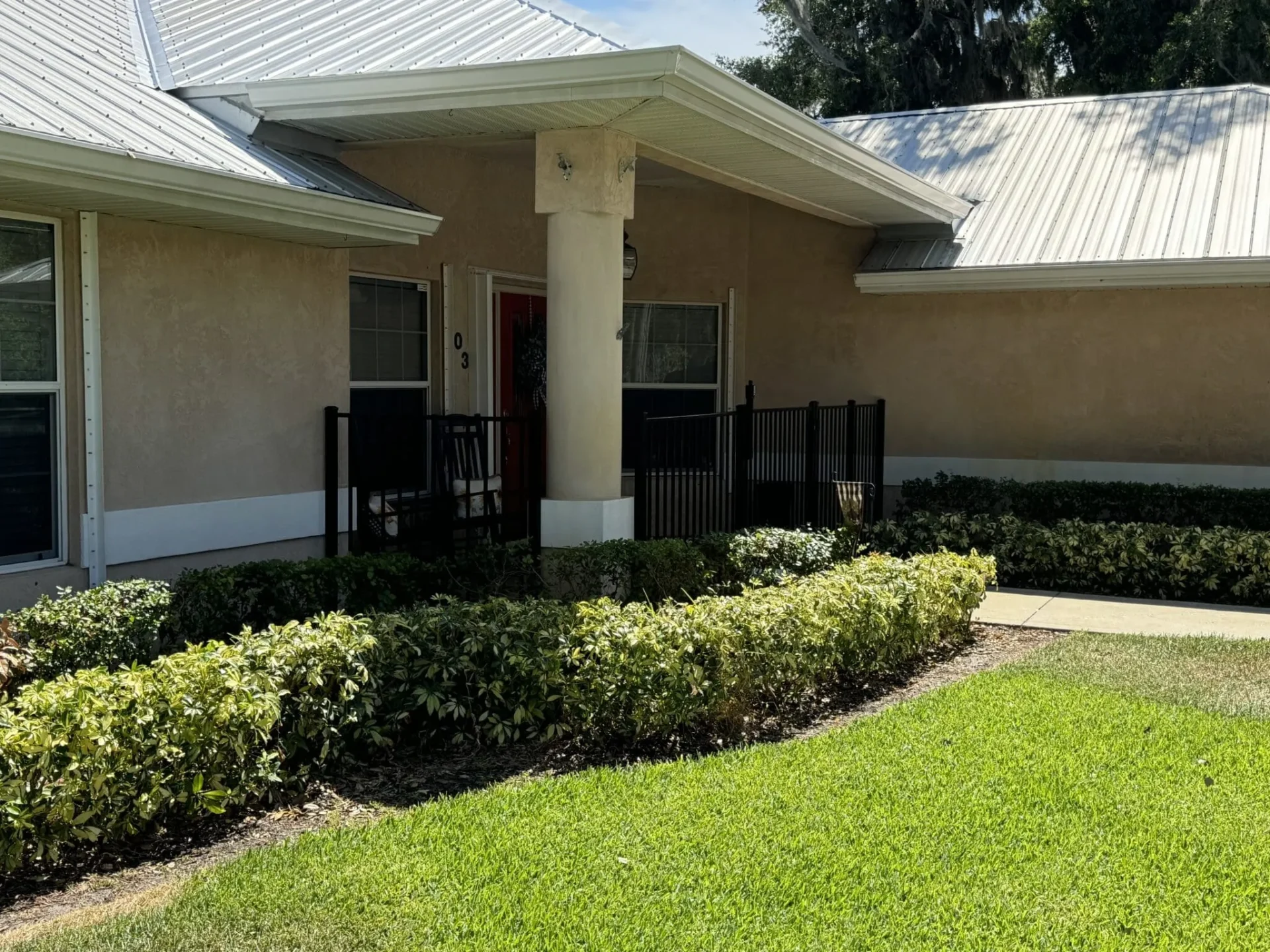 Residential home with green lawn and shrubs