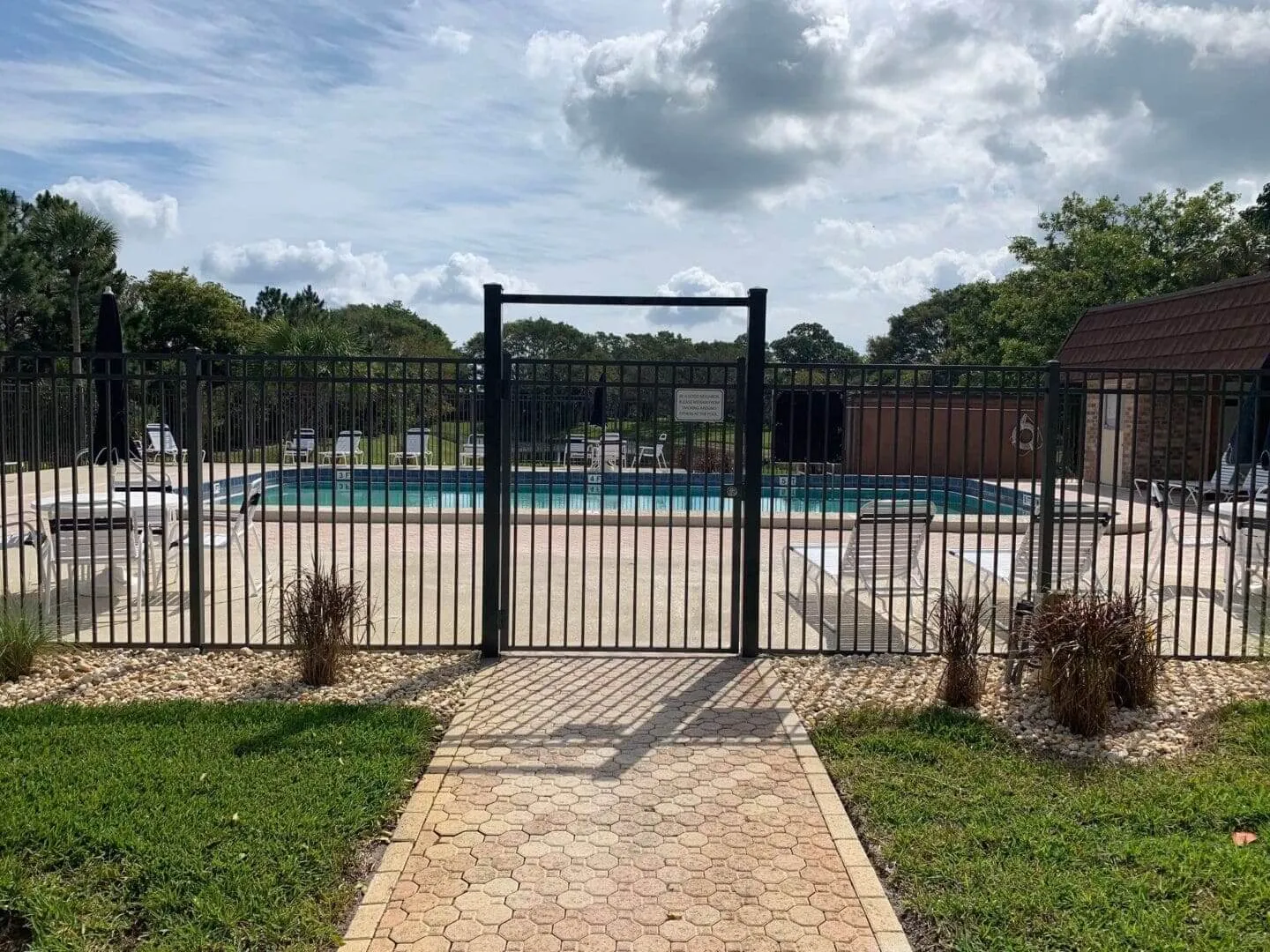 Empty swimming pool with surrounding fence
