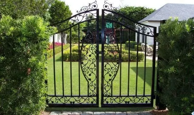 Decorative iron gate leading to garden