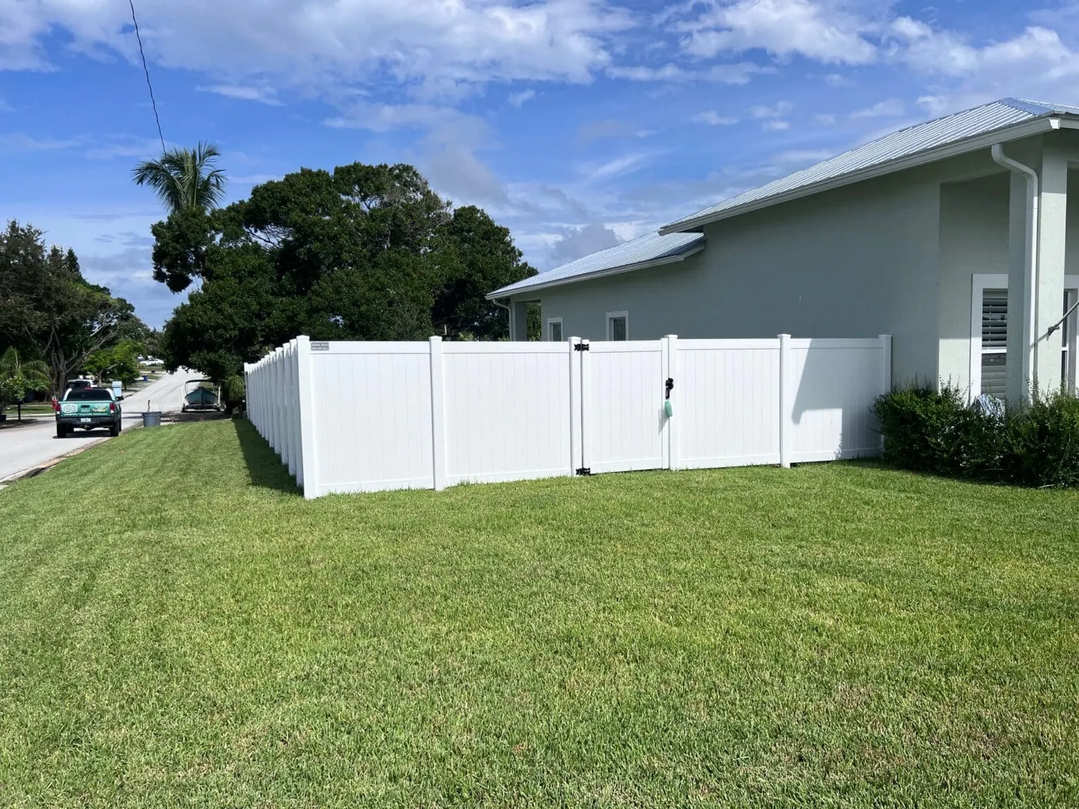 White fence surrounding a house