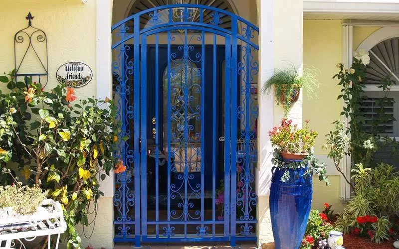 Decorative entrance with blue gate and flowers