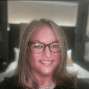 Smiling woman with glasses indoors