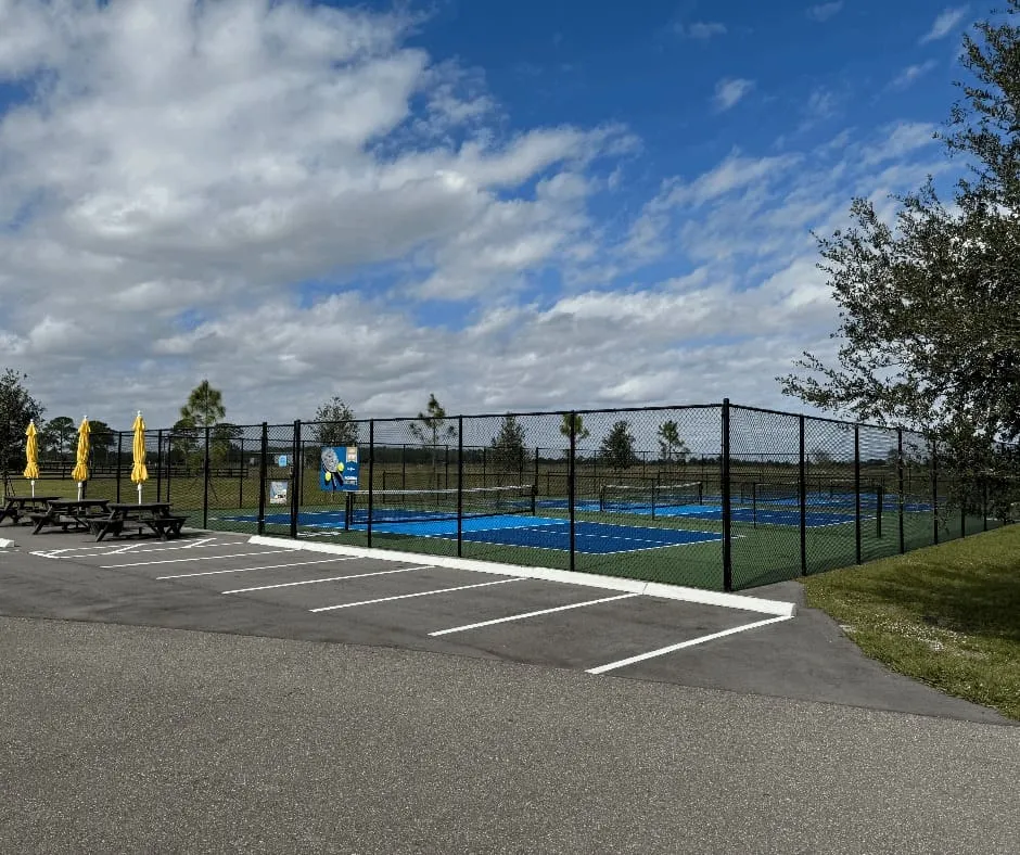Outdoor tennis courts with yellow umbrellas