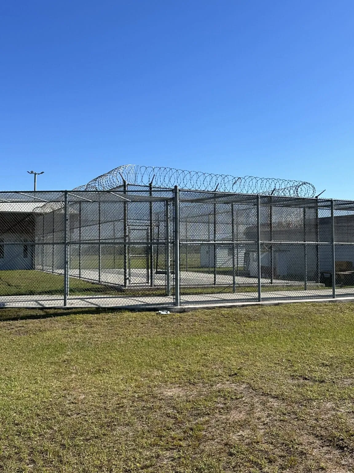 Secure facility perimeter with barbed wire