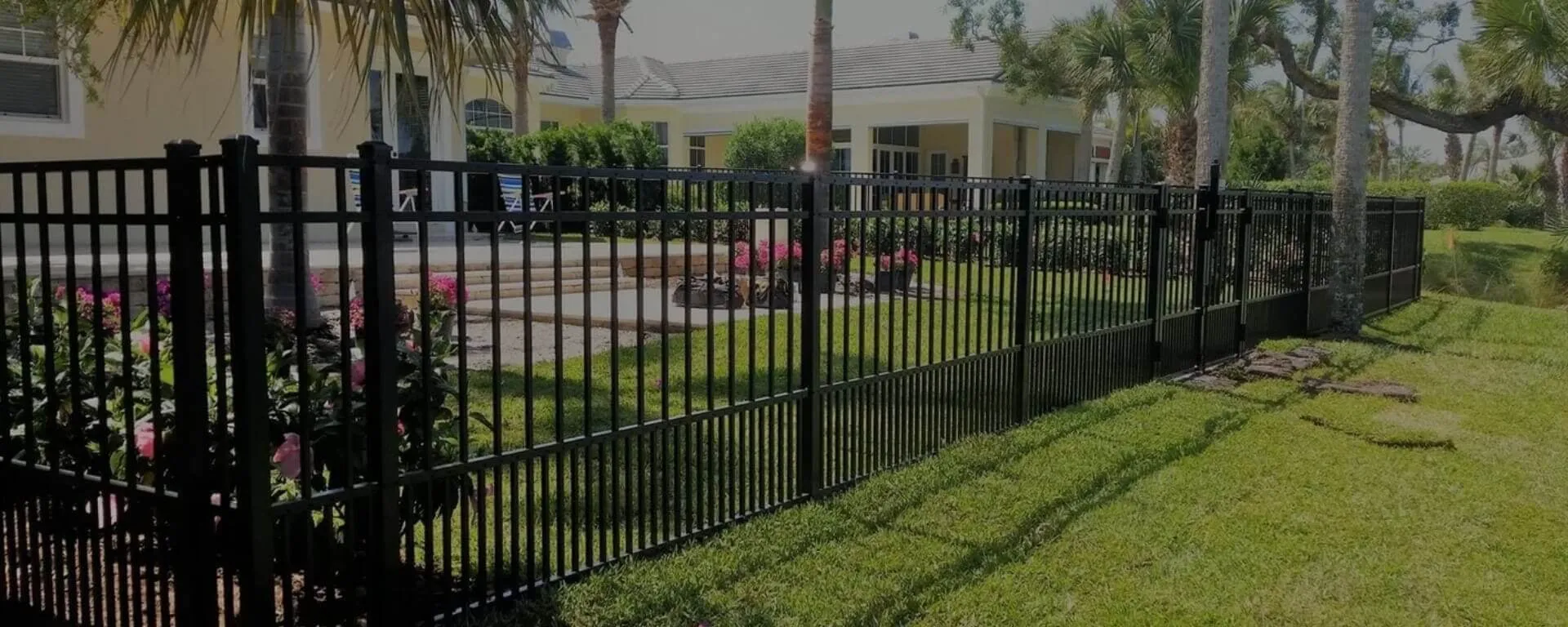 Black metal fence around garden area