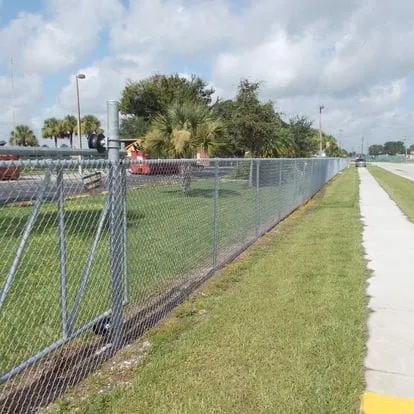 Chain-link fence with trees in background