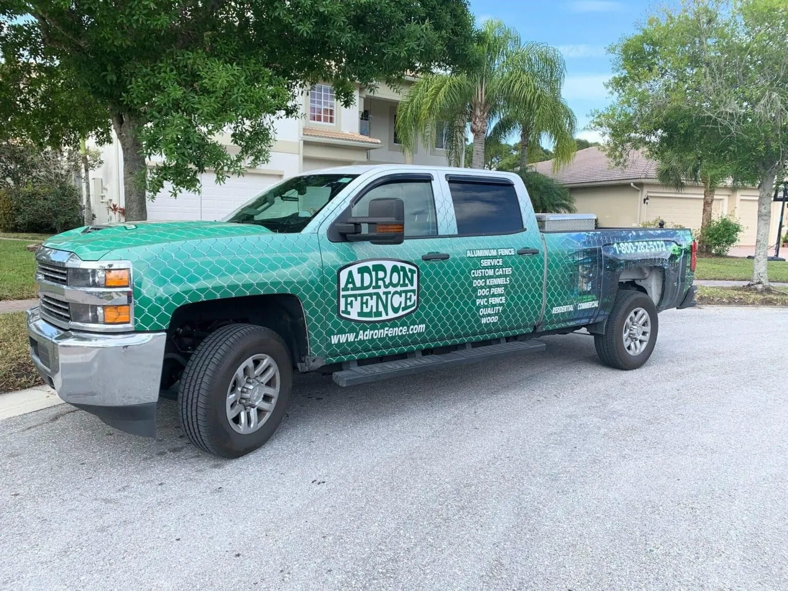 Branded truck with fence company details