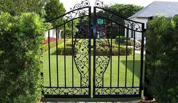 Elegant gate opening to landscaped garden