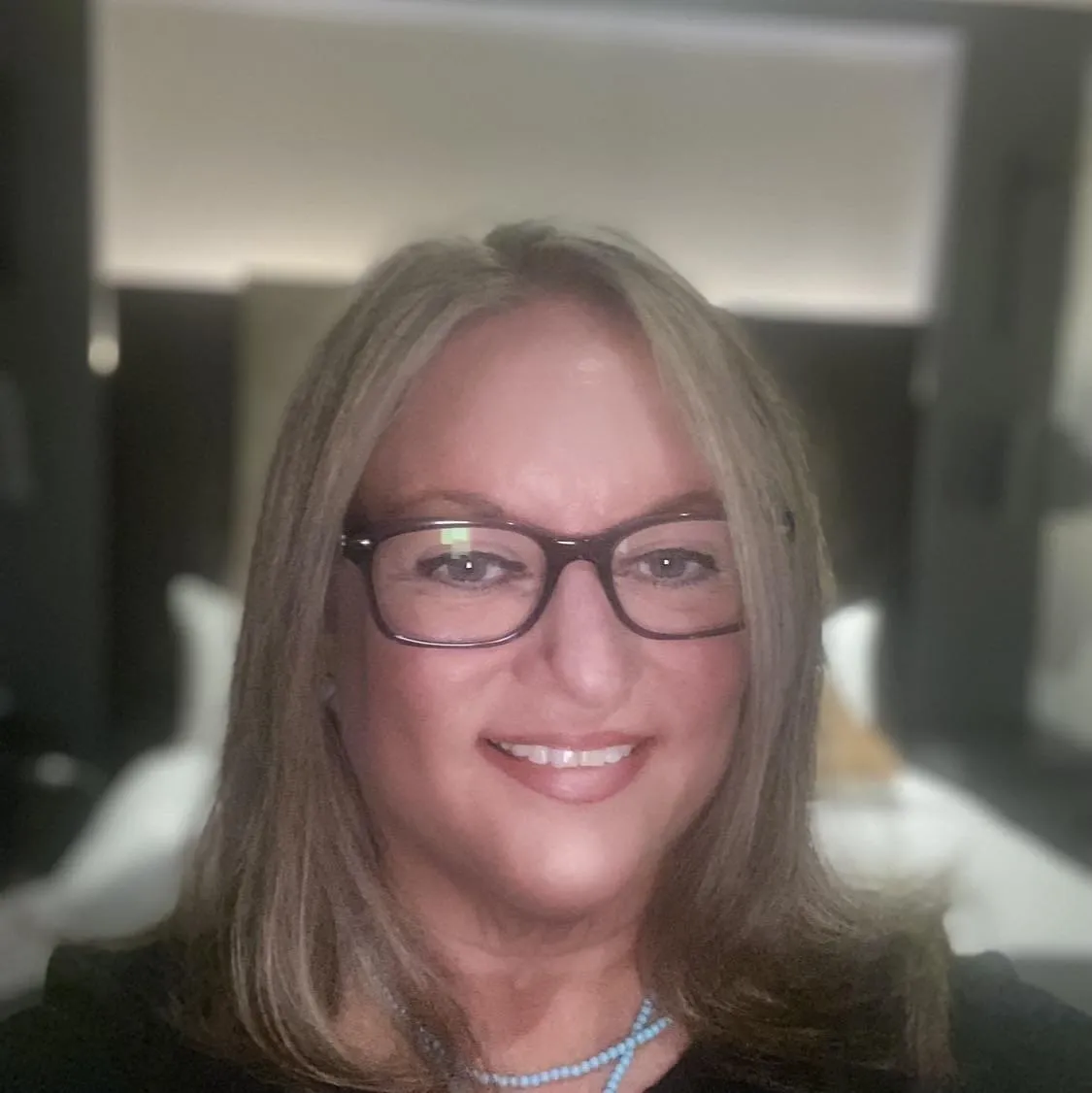 Woman with long hair and glasses