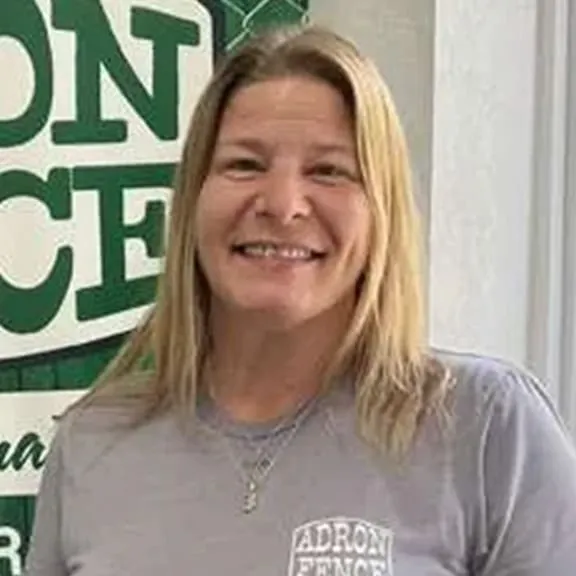 Woman with long hair and gray shirt.
